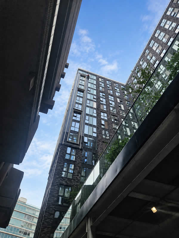 Wide shot showing the full height and scale of the high-rise building