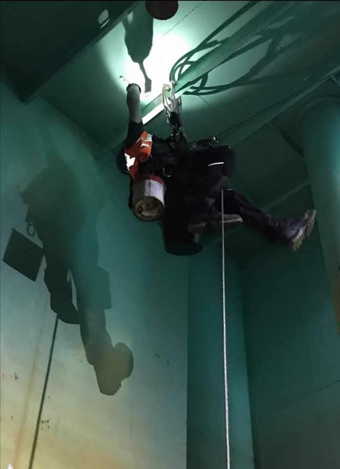 Rope access technician working inside a vessel ballast tank