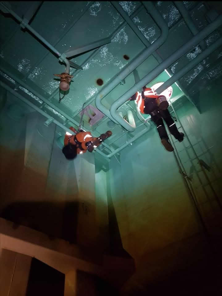 Technicians suspended inside the vessel ballast tank
